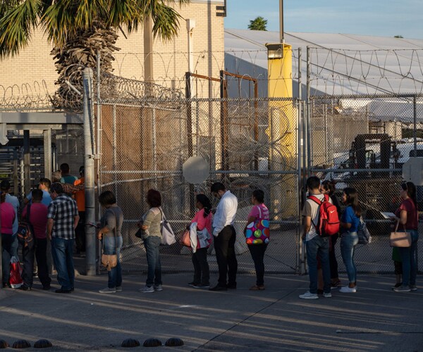 Migrants from Mexico wait to enter the United States