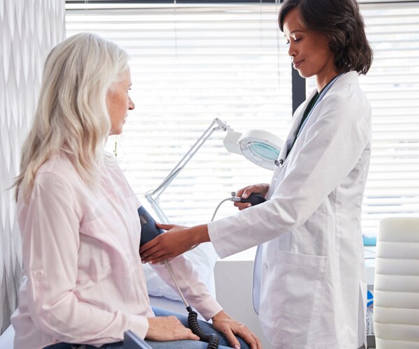 a doctor checks a patient's blood pressure