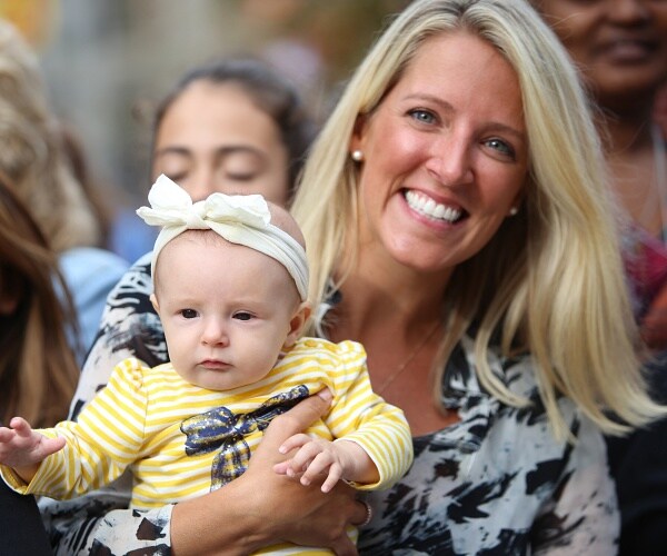 smiling mom holding infant