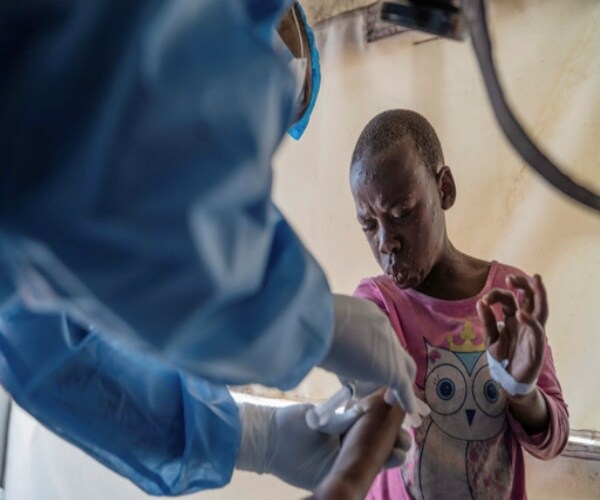 a boy receiving mpox vaccine in Africa
