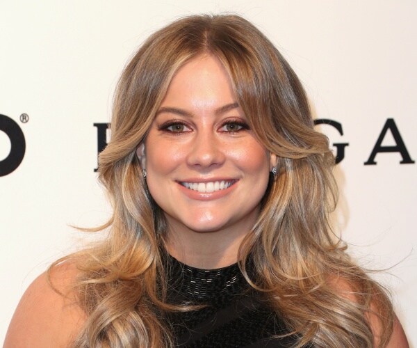 johnson in a black high neck dress smiling