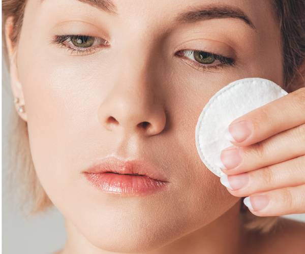 a woman removing makeup