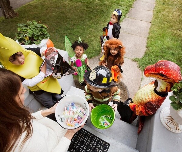 young children in costumes trick-or-treating