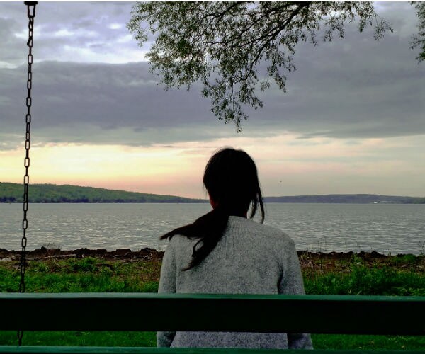 young woman shyly looking at camera