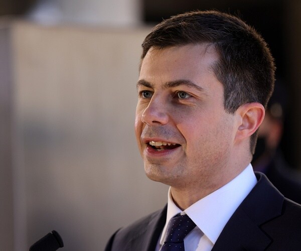 pete buttigieg speaks into microphone