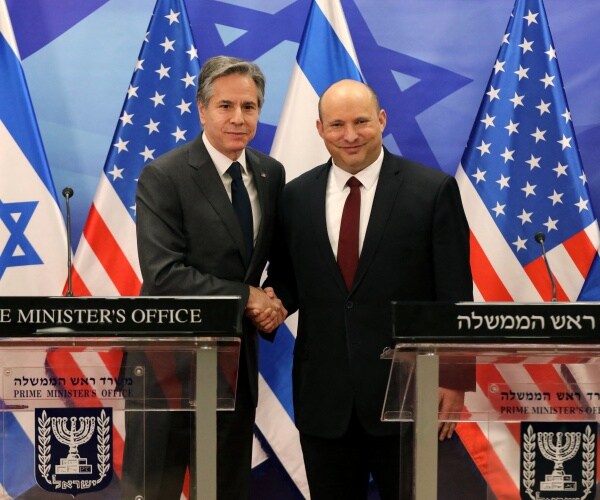 naftali bennett shakes hands with antony blinken
