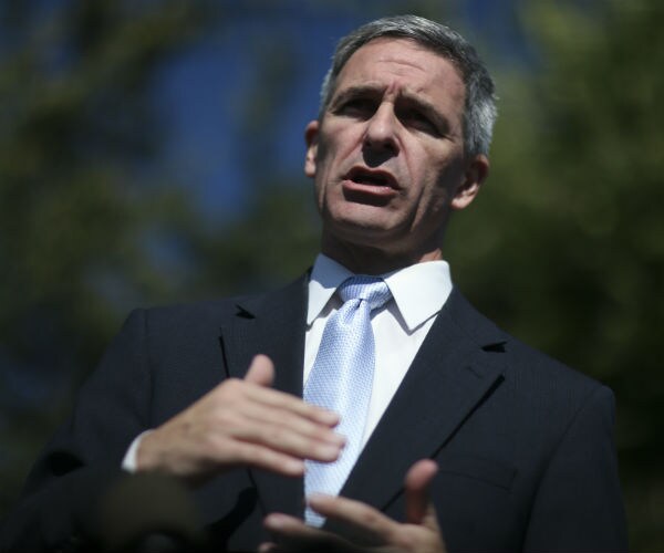 ken cuccinelli speaking at the white house in a dark suit, gray tie and white dress shirt