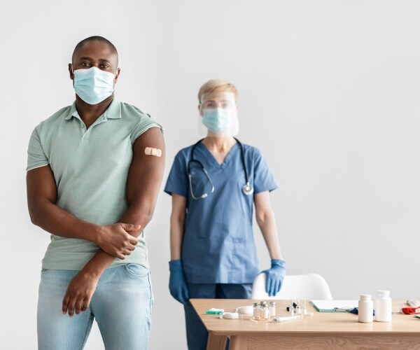 man getting recommended vaccine