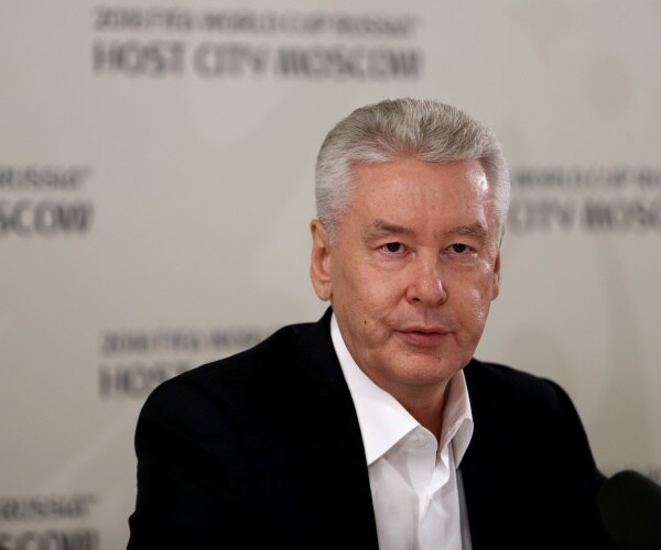 sobyanin in a black blazer and white dress shirt