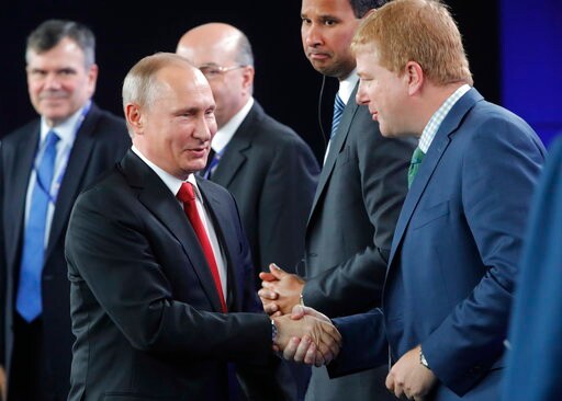 The Latest: Putin Avoids Criticizing Trump Climate Decision