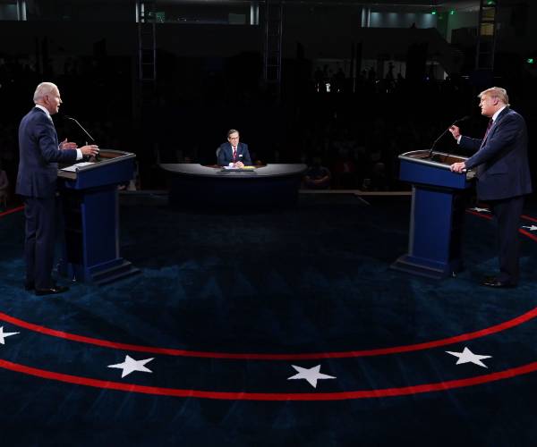 biden and trump at lecturns with moderator chris wallace seated in the center