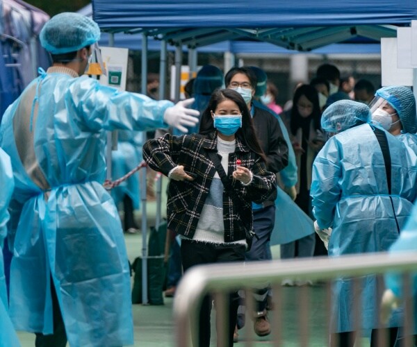 Medical staff directs residents at a makeshift COVID-19 testing station 