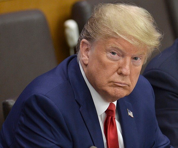 president trump sits with his hands folded at an UN meeting