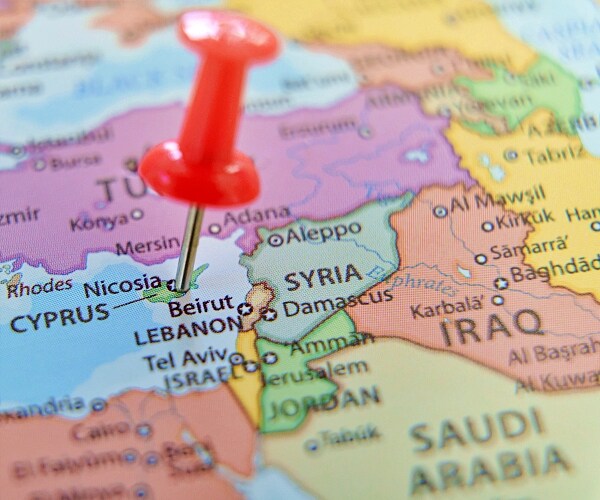 map with pushpin sticking into cyprus