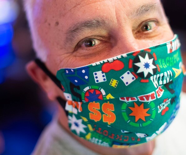 a man gambles wearing a casino themed mask in atlantic city