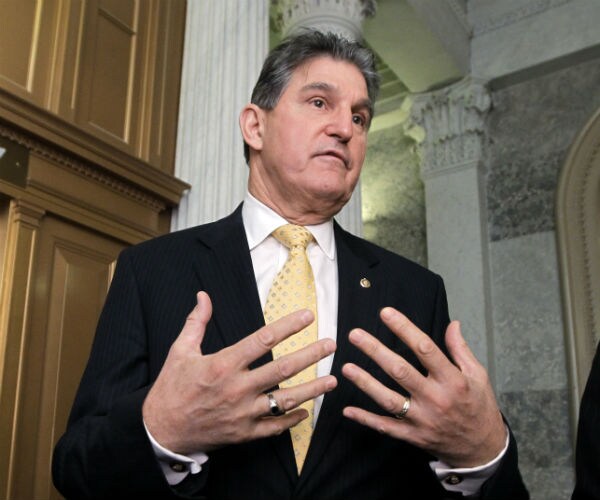 joe manchin gestures with his hands while speaking on capitol hill in washington