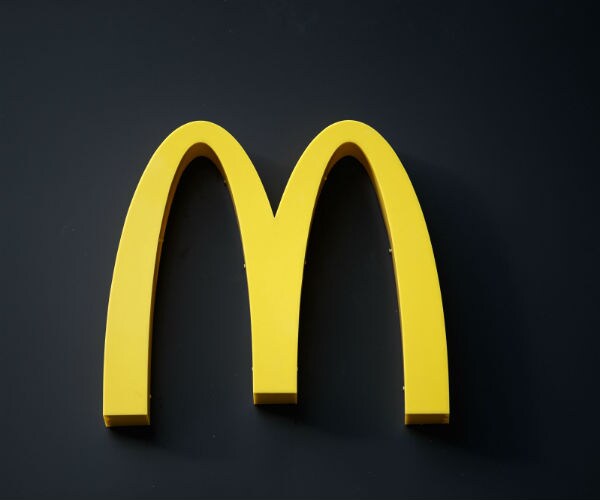 The McDonalds logo is shown in yellow with a black background.