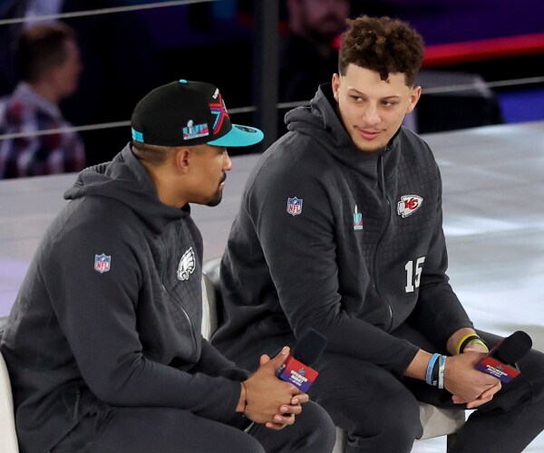 hurts and mohomes in sweats holding microphones