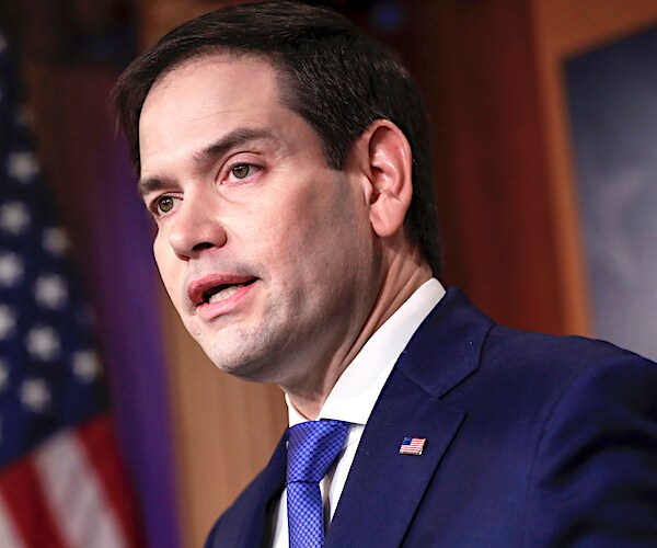 marco rubio speaks into a mic during a news conference