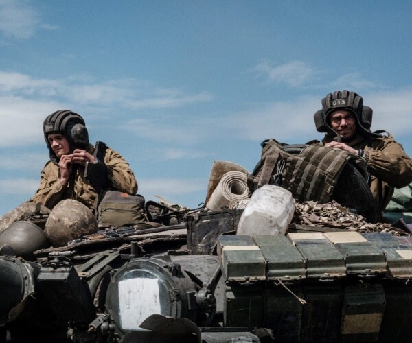 ukrainian soldiers sit on a tank