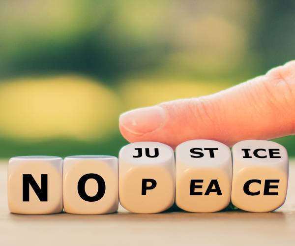 dice with the words illustrating no justice no peace