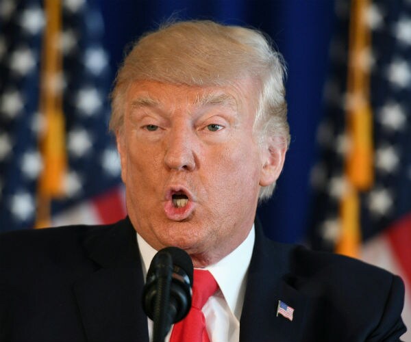 donald trump is shown in a dark suit, white dress shirt and red tie