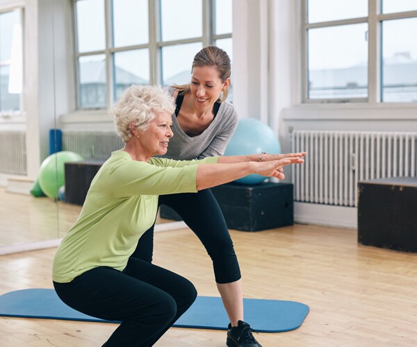 An elderly woman exercising