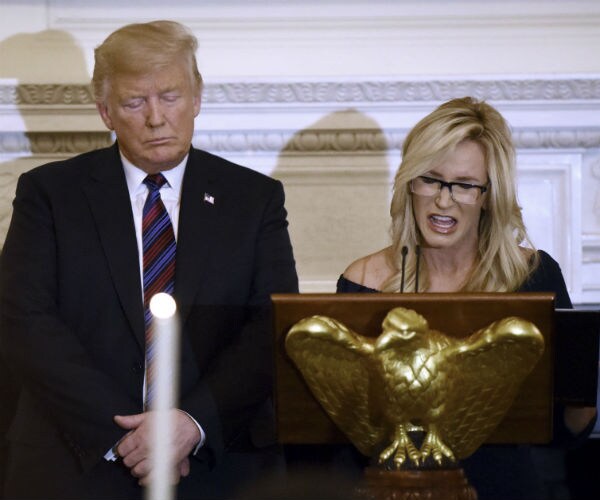 President Donald Trump listens to Evangelist and Pastor, Paula White as she leads the prayer.