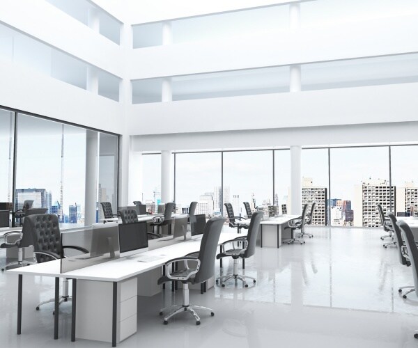 modern looking office space with many grey chairs and large windows with sunlight coming in