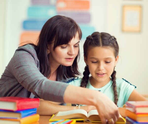 teacher helping a student
