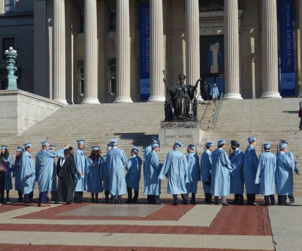 Graduates at a school within Columbia University booed the institution's acting president and chante...