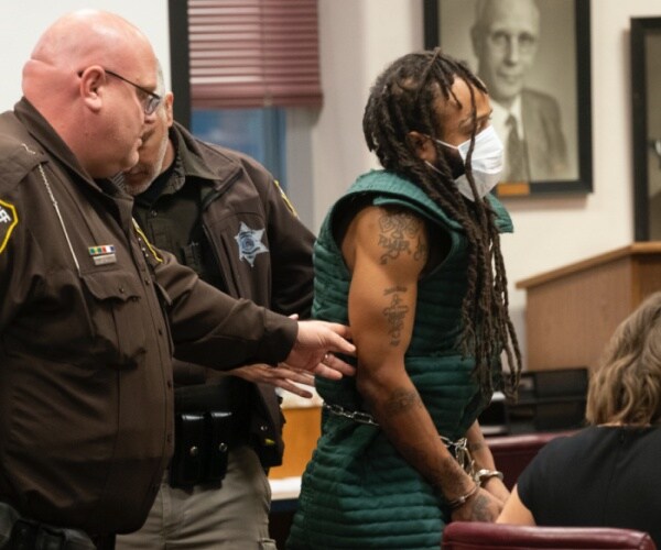 Darrell Brooks in court with guards and court staff.