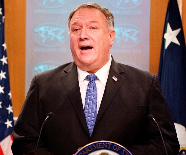 mike pompeo speaks into microphone
