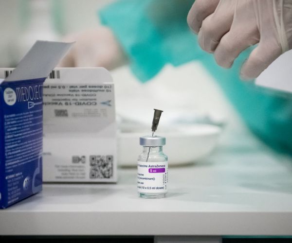 an AstraZeneca vaccine vial on a table