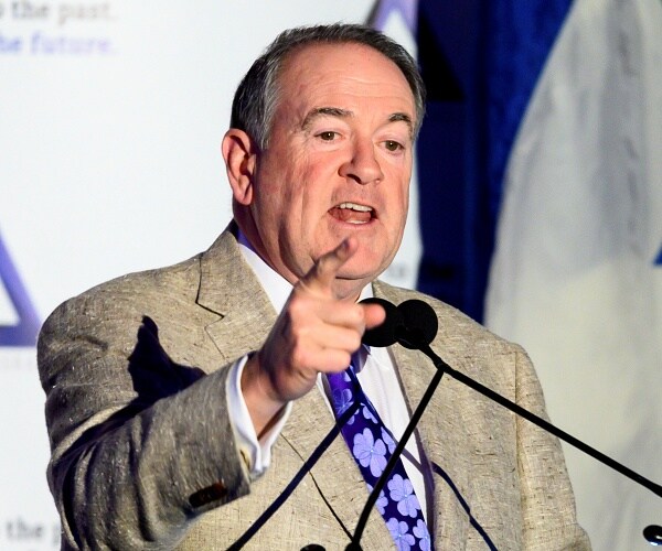 mike huckabee points at crowd from stage