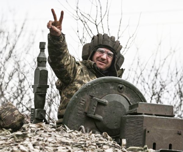 A Ukrainian soldier makes the victory sign.