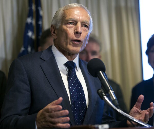 gen. wesley clark is gestures as he speaks during a news conference with retired military officers