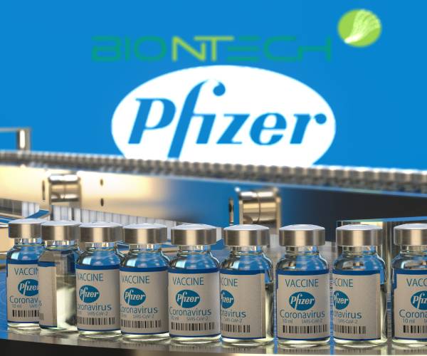 vials of pfizer vaccine on an assembly line