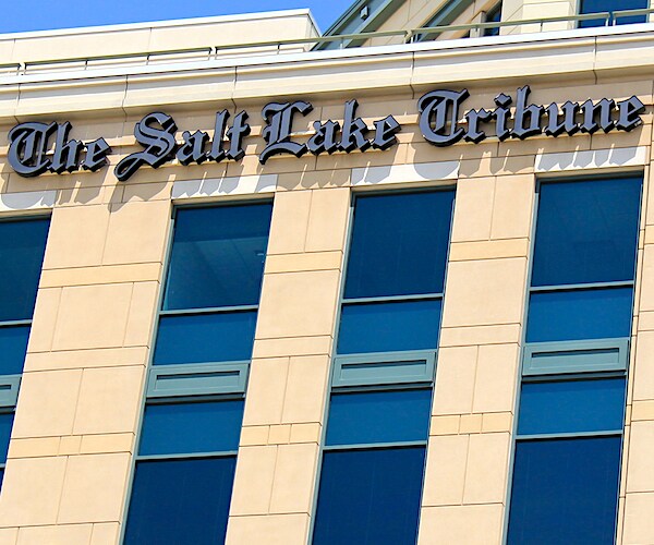 the salt lake tribune building before a blue sky