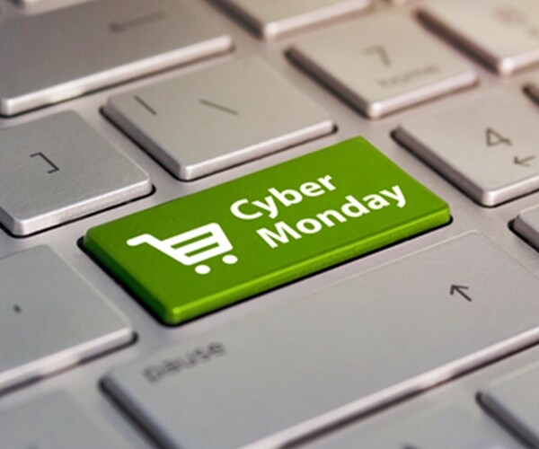 cyber monday and shopping trolley symbol on notebook gray keyboard.