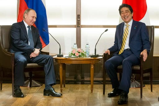 The Latest: Putin Visits Judo Center in Downtown Tokyo