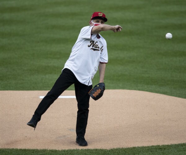 Dr. Anthony Fauci throws out a ceremonial first pitch before an opening day baseball game in Washington. 