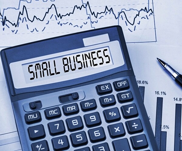 pen, business chart and calculator with small business in display window