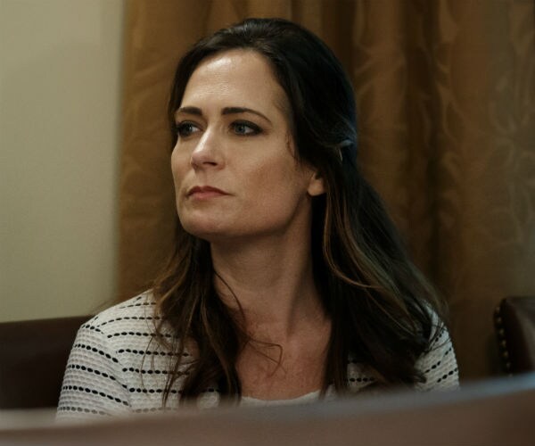 stephanie grisham is shown in a black and white stripped shirt