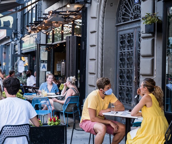 diners eat outside at a restaurant in new york city