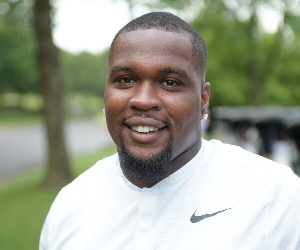 antonio andrews stands on golf course