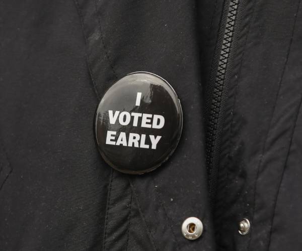 a person wearing a pin that says i voted early
