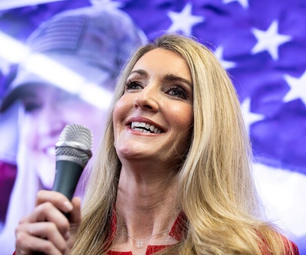 kelly loeffler holds microphone