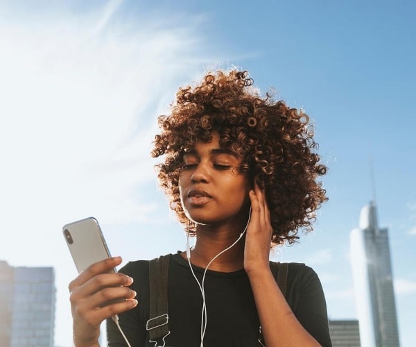 young woman listening to music in headphones