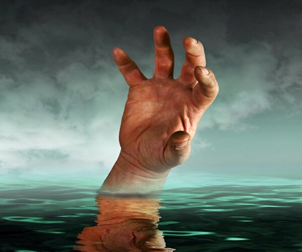 drowning hand depicting business going under 